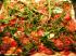 Rucola-Pizza mit Parmaschinken, Mozzarella und Tomaten....
