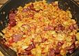 Patatas con chorizo en salsa de naranje