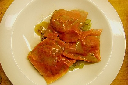 Rote Ravioli mit Gansf&uuml;llung auf einem Selleriebett
