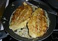 Pangasius in Parmesanh&uuml;lle gebacken mit Tomatensauce