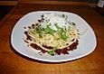 Spaghetti auf angebratenen, sonnengetrockneten Tomaten mit Rucola und Parmesan