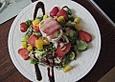 Gebackener Ziegenk&auml;se im Speckmantel auf fruchtigem Salat mit Honig-Senf-Vinaigrette