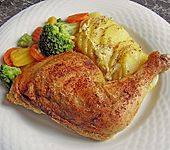 Gebackene H&auml;hnchenkeulen auf Kartoffeln (Bild)