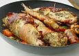 Kaninchen mit Tomaten und Oliven